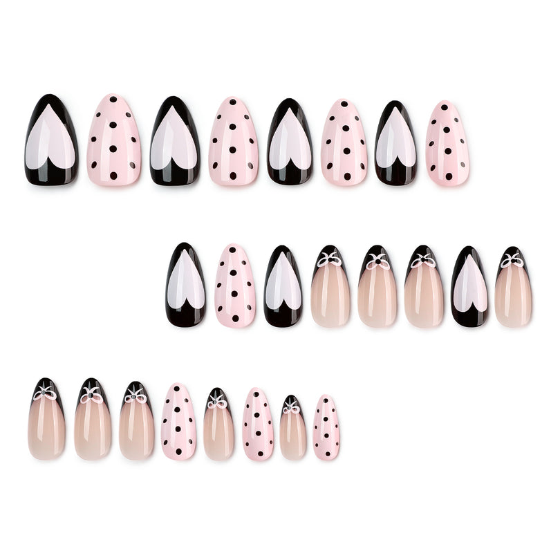 Set of 24 black, pink, and nude press-on nails with hearts and polka dots.