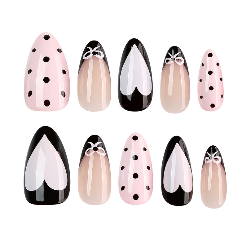 Ten press-on nails displayed in two rows with heart and polka dot designs.