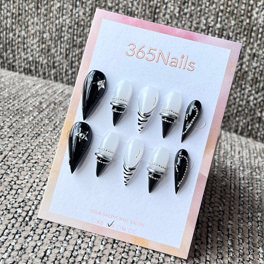 Black and White Stiletto Press-On Nails with Star Charms and Silver Rings