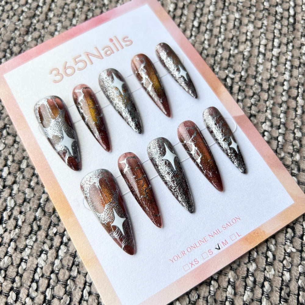 Femme Fatale: "Amber Galaxy" – Deep Bronze Cat Eye with Crushed Silver Foil & White Starburst Long Stiletto Nails
