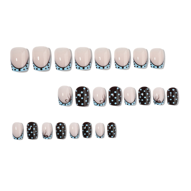 Full set of 24 short square press-on nails with polka dot and french tip designs laid out in rows