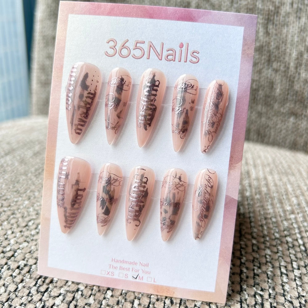 Femme Fatale: "Urban Scripture" – Nude Pink Jelly Base with Black Ink Smudge & Silver Gothic Lettering Long Stiletto Nails