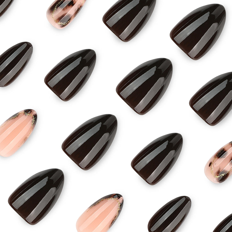 Close-up top view of glossy dark brown and leopard print almond nail tips scattered on a white surface.