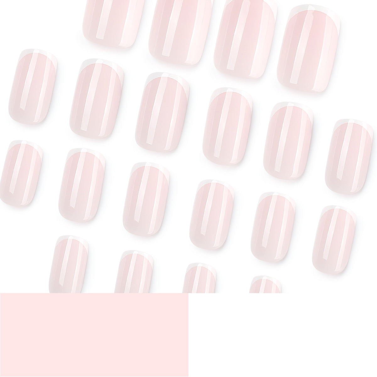 Many pale pink French tip press-on nails scattered on a white background