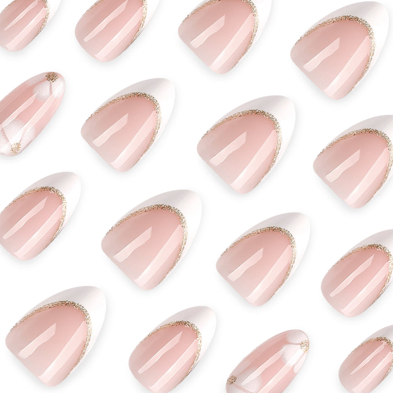 Close-up of glossy almond nails with pink nude body, white tip and gold glitter border