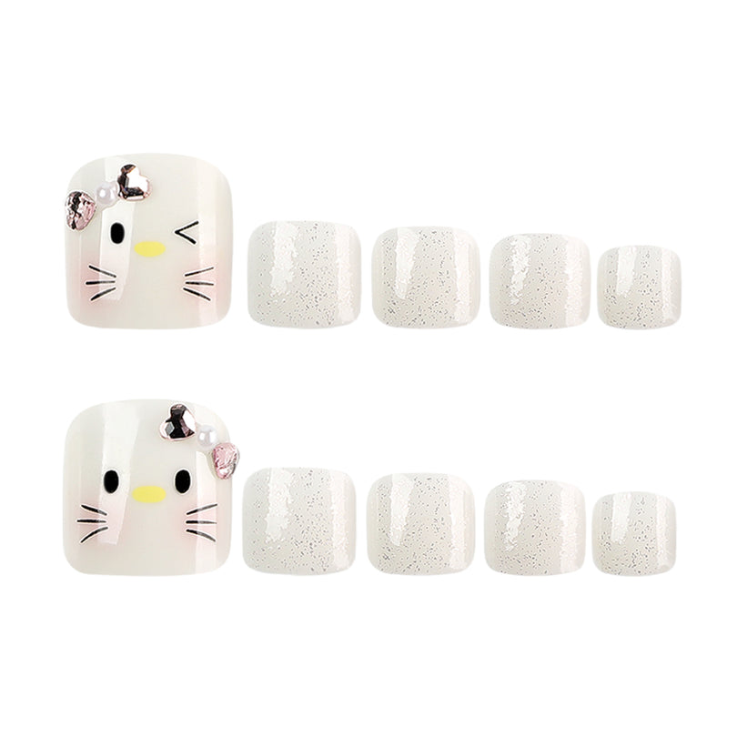 Two cat-face press-on toenails displayed with rows of silver glitter accent nails.