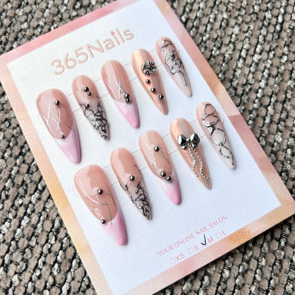 Femme Fatale: "Cyber Coquette" – Nude Pink Ombré Base with Liquid Silver Lines, Metal Bow & Chain Charms Long Almond Nails