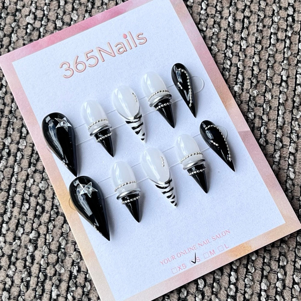 Black and White Stiletto Press-On Nails with Star Charms and Silver Rings