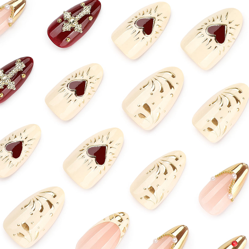 Close-up of cream, wine red and chrome gold press-on nails with rhinestones