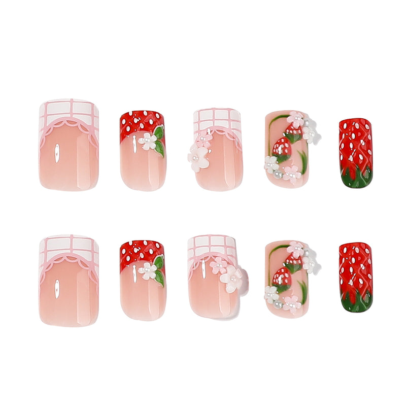 Ten short square press-on nails displayed with strawberry and lace nail art