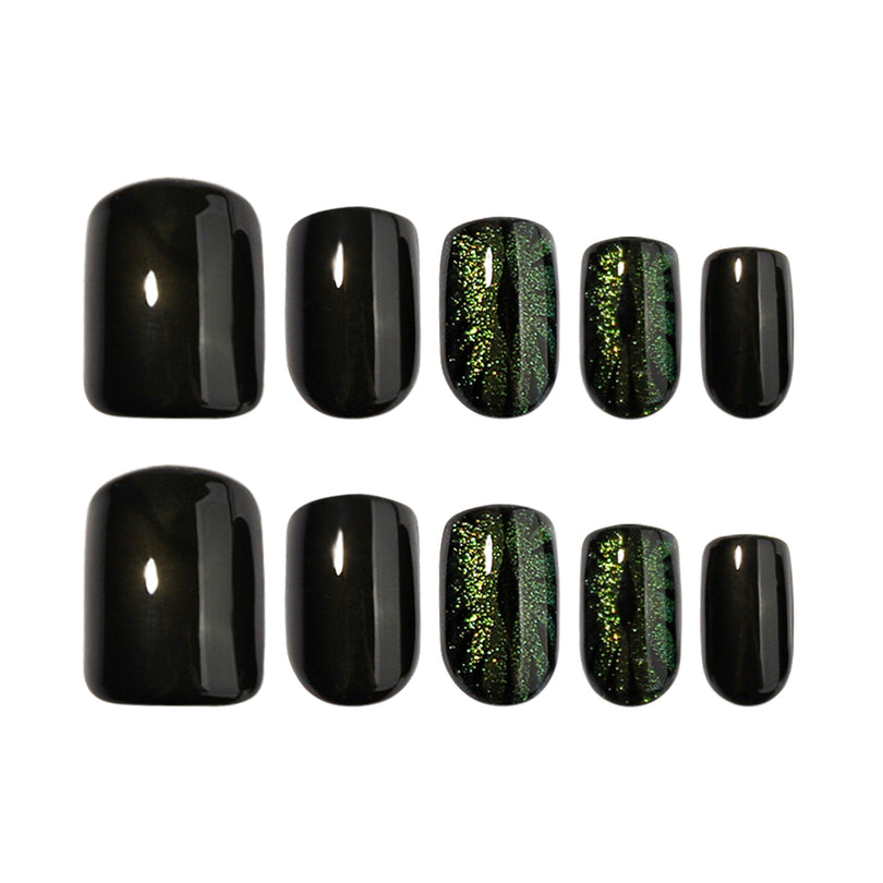 Ten black and green cat-eye press-on nails in assorted sizes