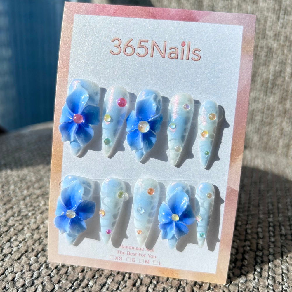 Sculpted Flora: "Frosty Bluebell Dream" – 3D Gradient Blue Flowers on Pearlescent White Nails with Aurora Gems