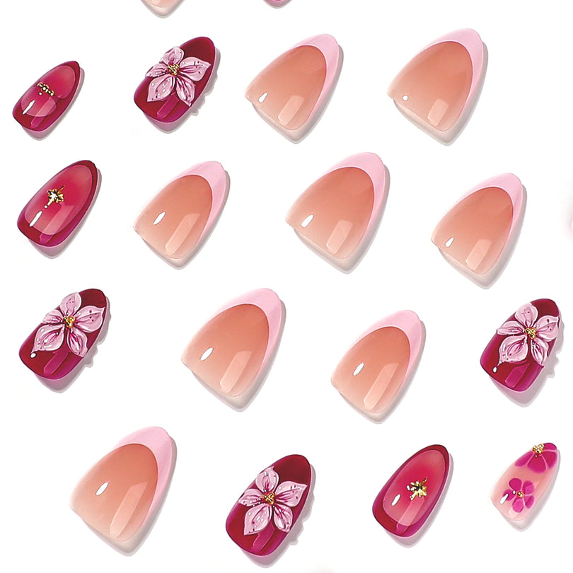 Close-up of individual almond press-on nails with 3D flower and gold accents