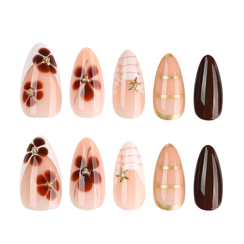 Flat lay of press-on nail set with floral and solid brown designs