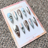 Femme Fatale: "Chrome Saint" – Icy Aurora & Metallic Bronze Mix with 3D Gothic Cross & Liquid Silver Lines Long Stiletto Nails