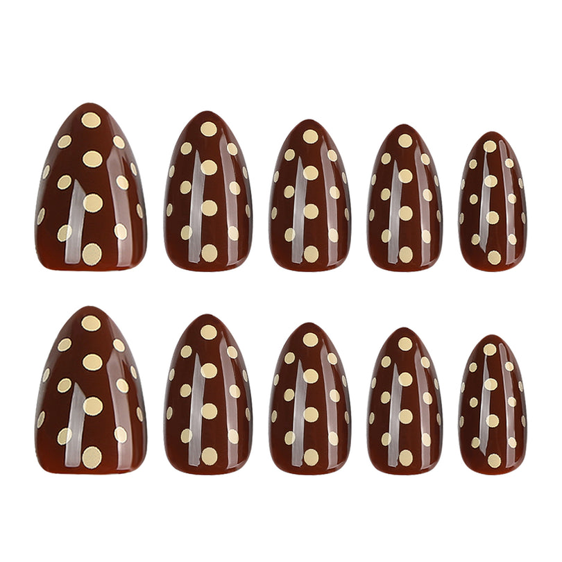 Twenty-four brown press-on nails with cream polka dots