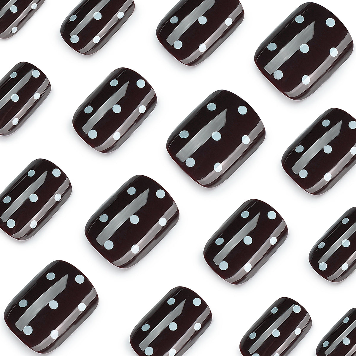 Close-up of glossy black square nails with white polka dots