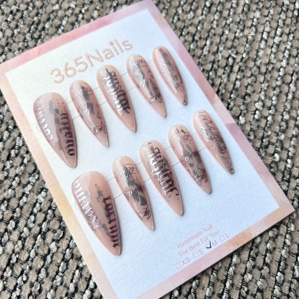 Femme Fatale: "Urban Scripture" – Nude Pink Jelly Base with Black Ink Smudge & Silver Gothic Lettering Long Stiletto Nails