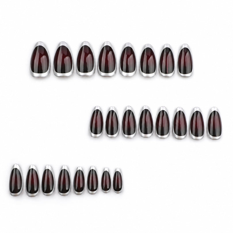 Set of dark red almond nails with silver rims arranged in three rows on white background