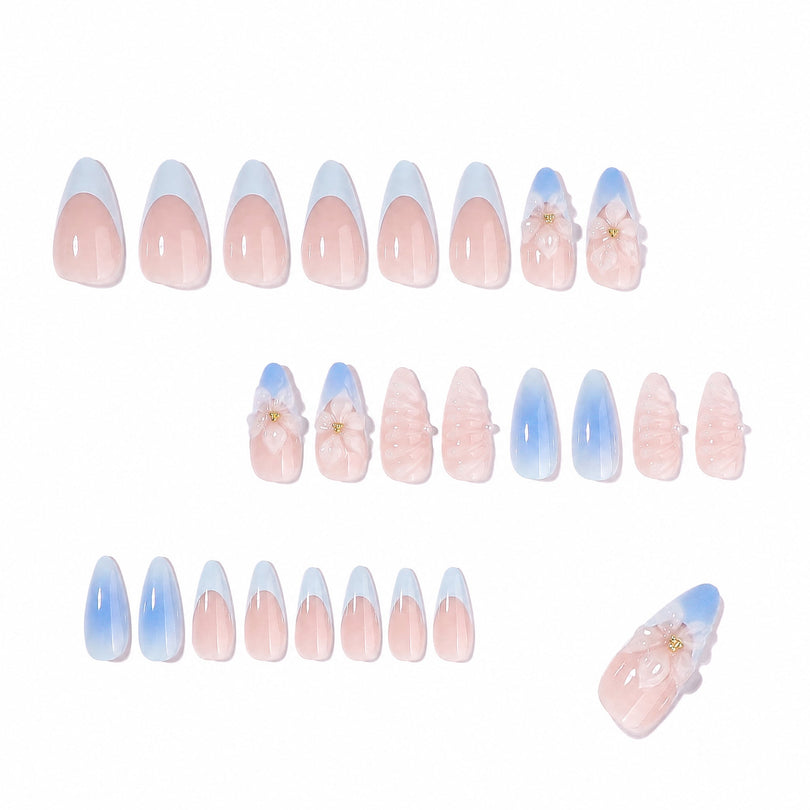 Full set layout of press-on nails with pink bases, blue tips and 3D floral decorations