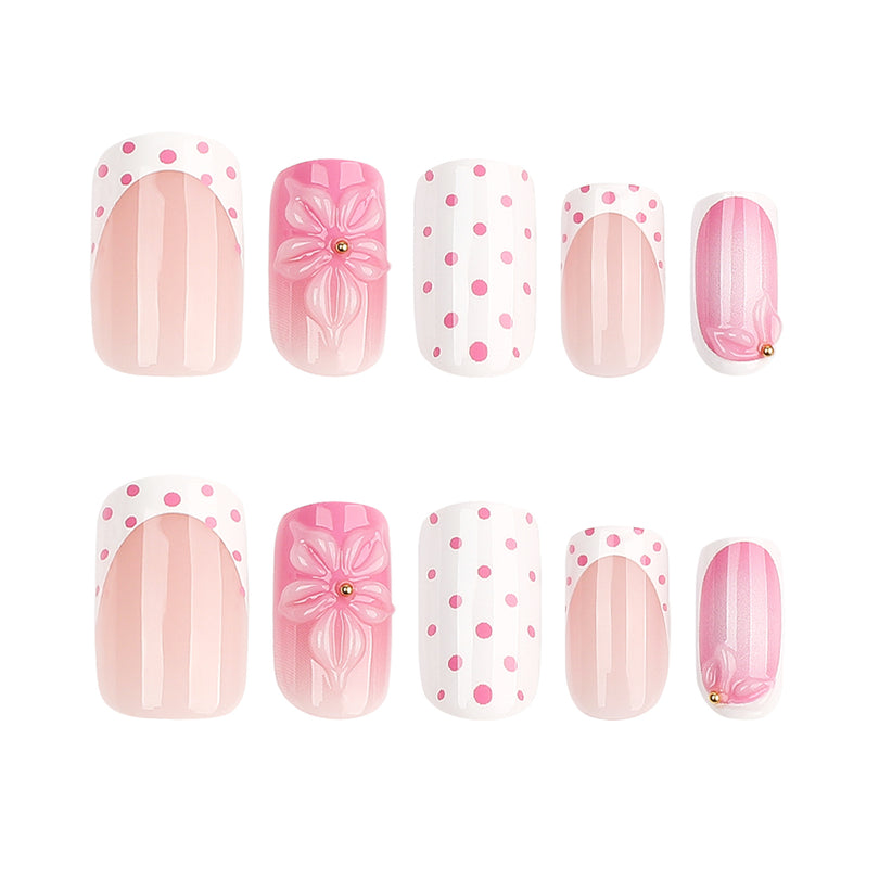 Ten pink and white press-on nails arranged in two rows