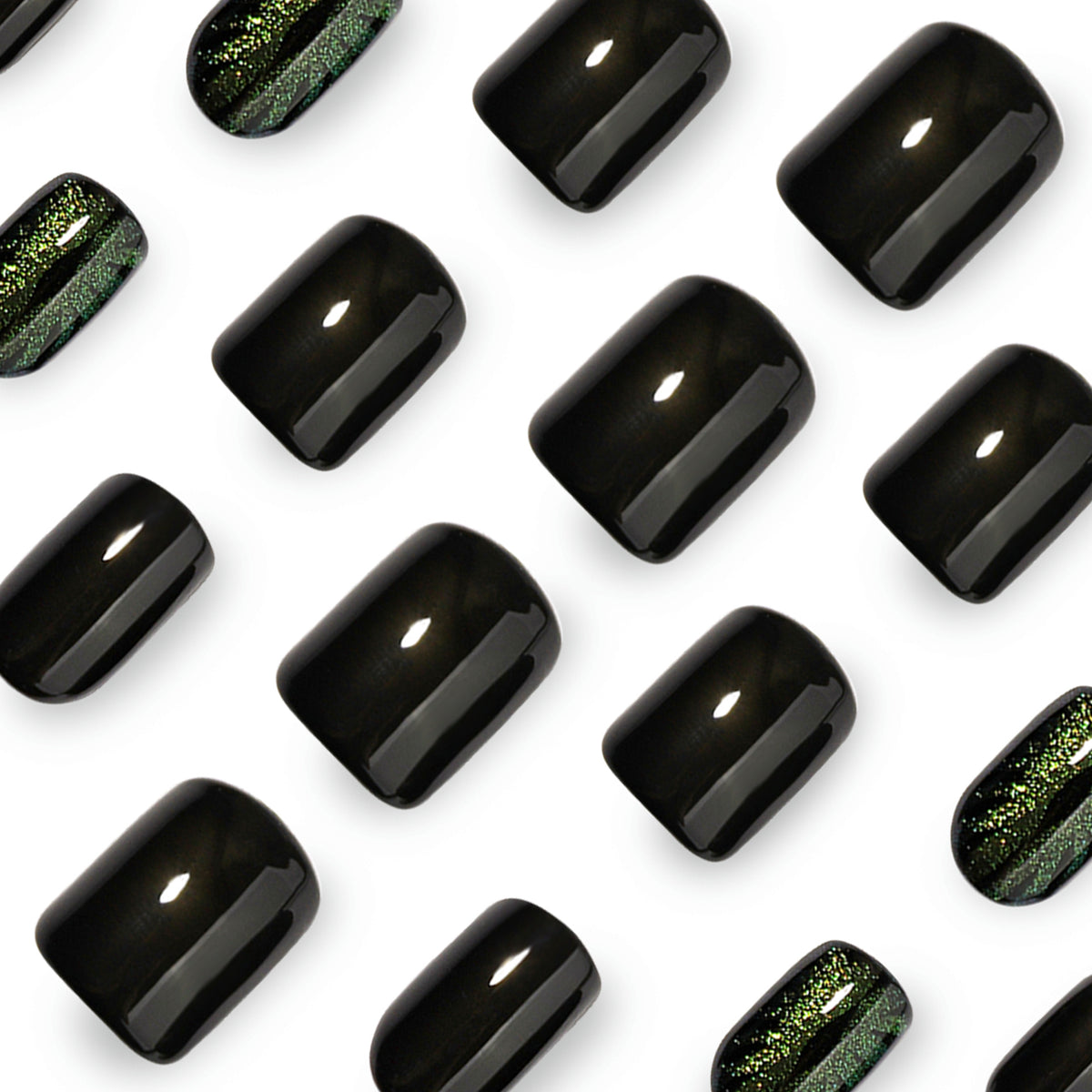 Close-up of glossy black and green cat-eye press-on nail tips