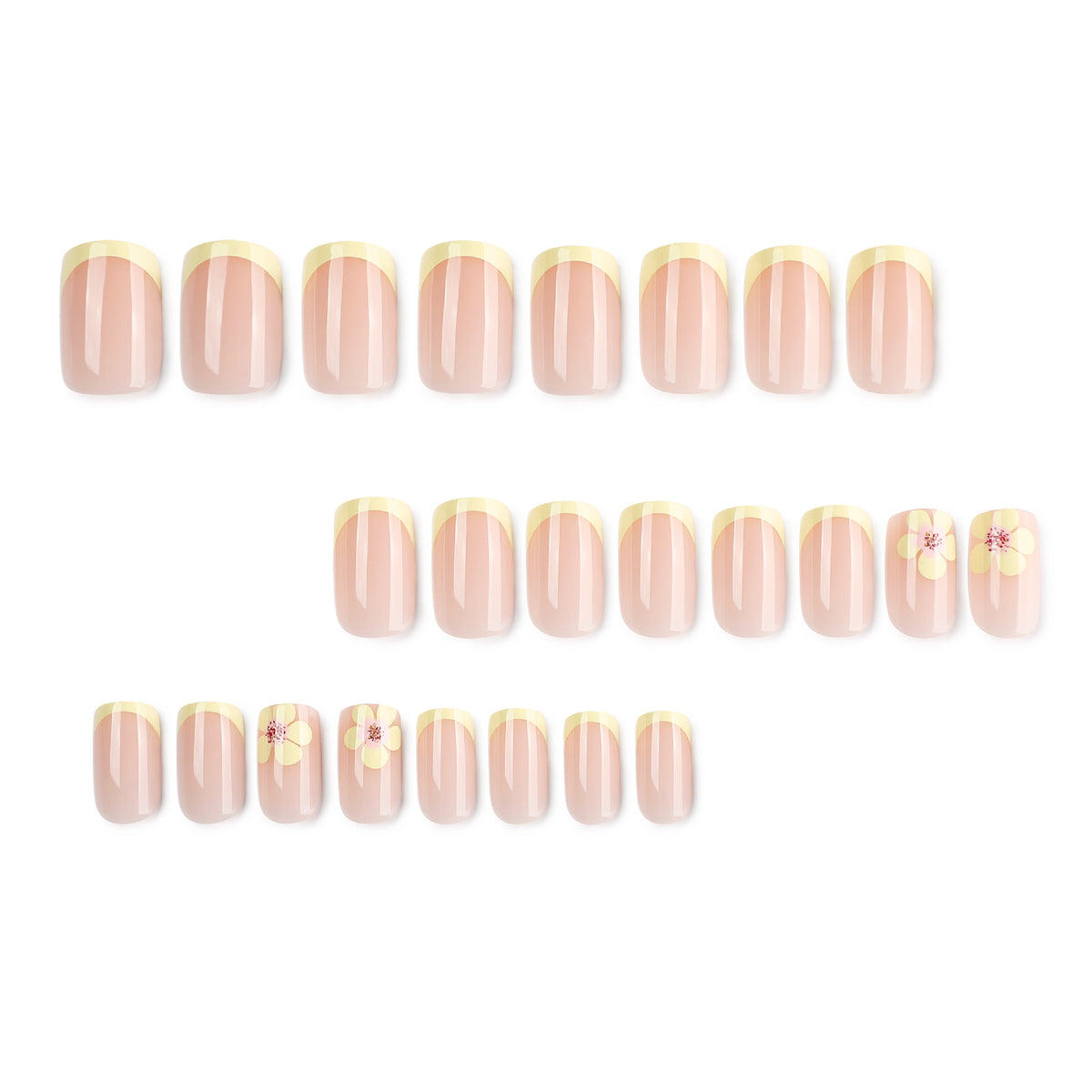 Full set of 24 nude press-on nails with yellow french tips laid out in rows