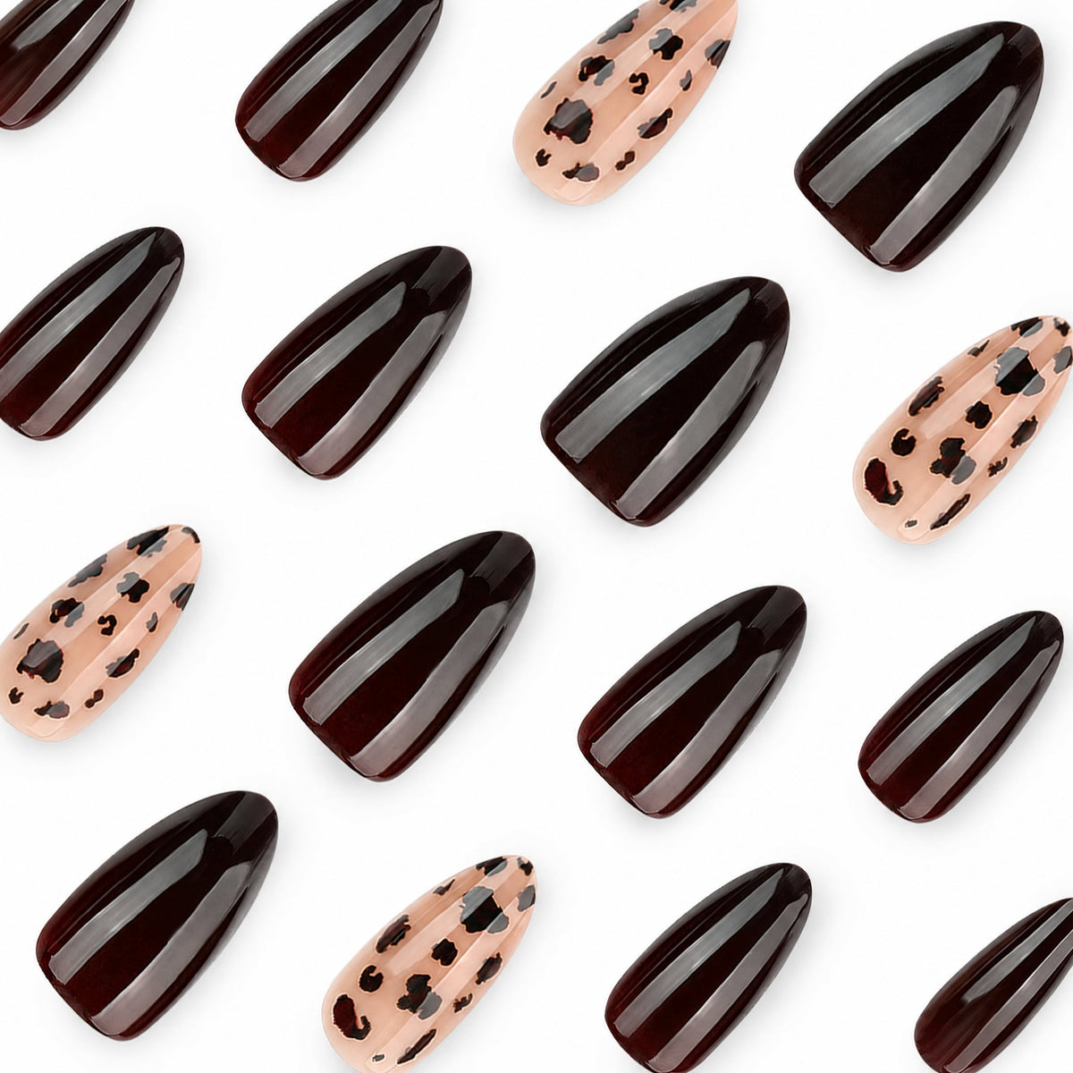 Close-up of glossy dark brown and nude leopard print almond nail tips arranged on white