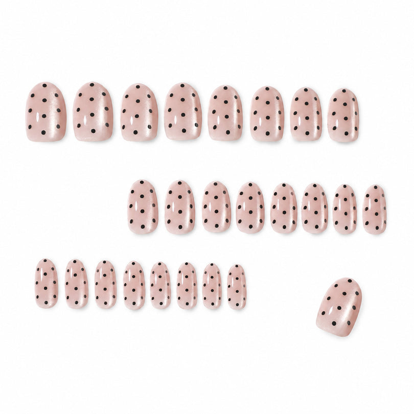 Set of 24 nude pink polka dot press-on nails laid out in rows
