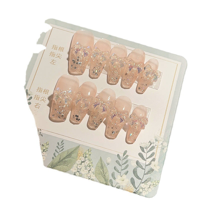 Ongles paillettes aurore avec breloques nœud irisé