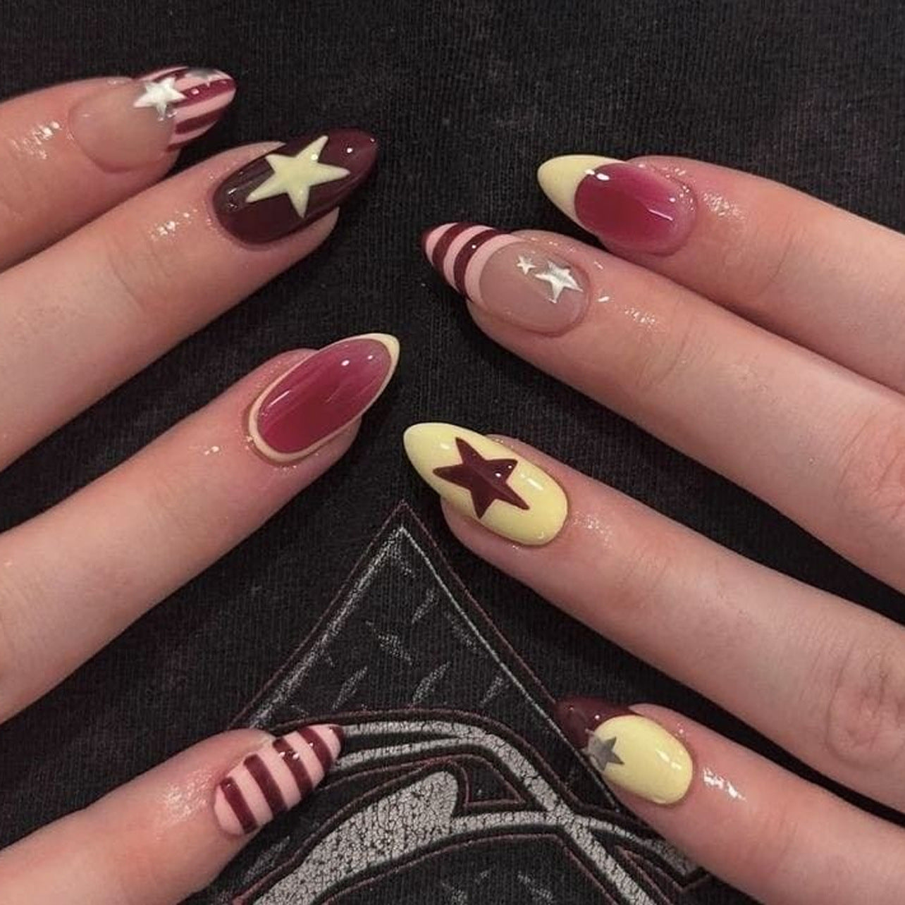 Almond-shaped press-on nails with star accents