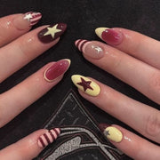 Almond-shaped press-on nails with star accents