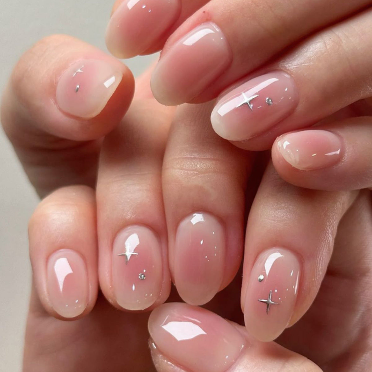Soft Pink Gloss Nails with Subtle Silver Star Accents