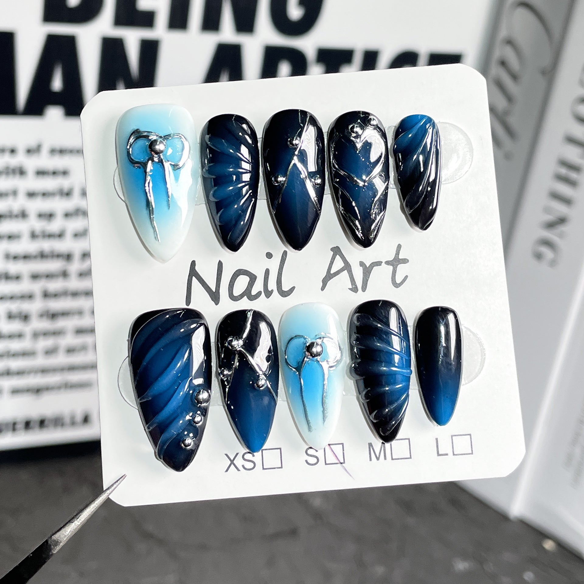 Hand-Painted Blue Gradient Nails with Sculpted Metallic Bow Accents