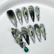 Edgy Press-On Nails with Green Chrome Accents and Snake Charm
