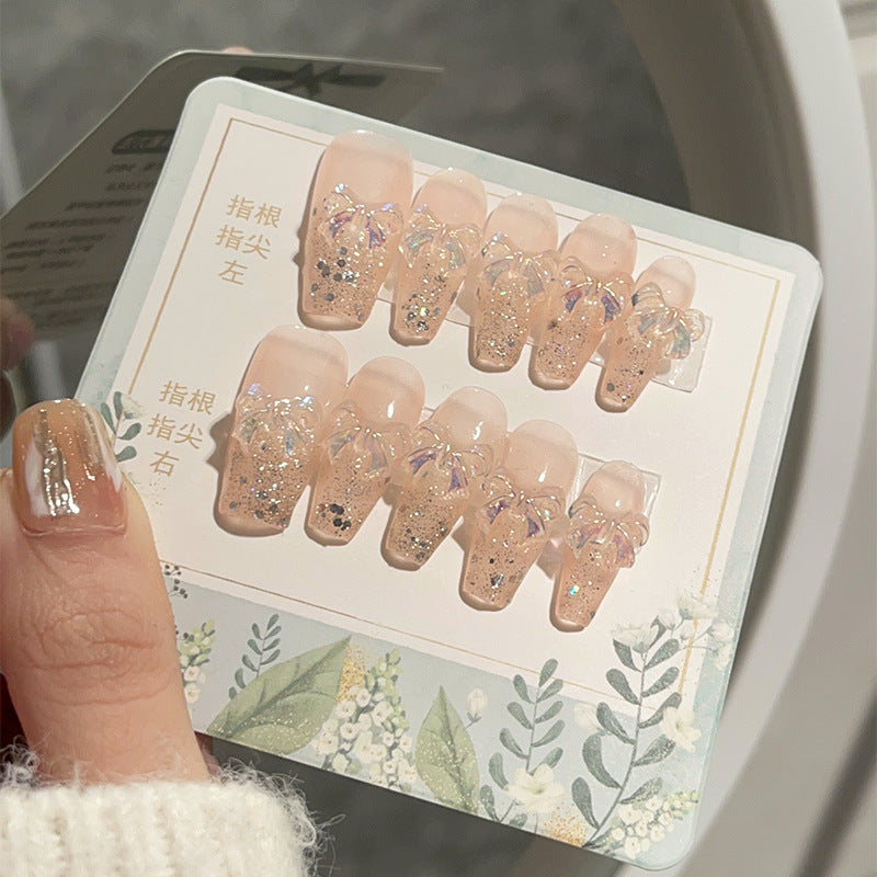 Ongles paillettes aurore avec breloques nœud irisé