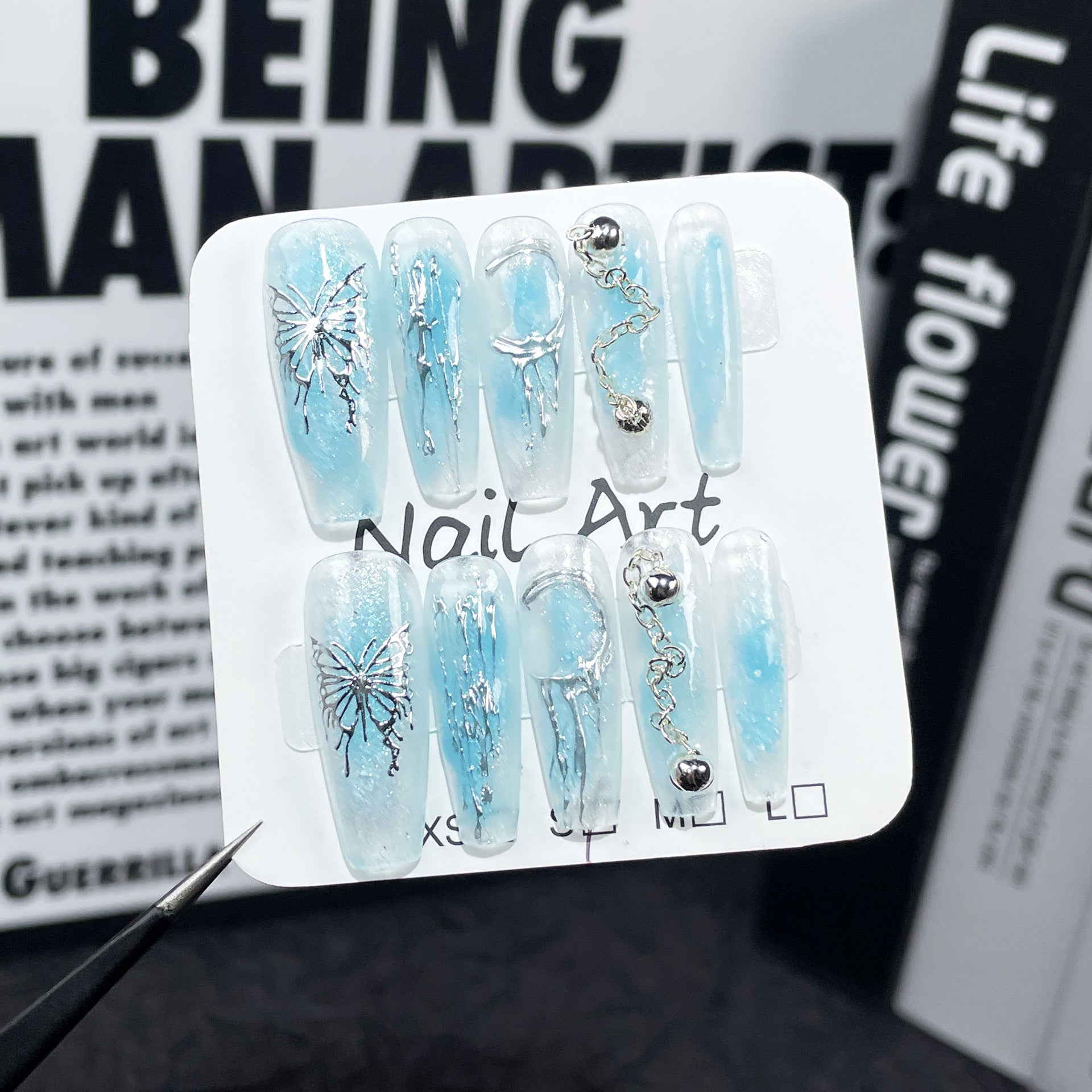 Ocean-Blue Nails with Metallic Butterfly and Sculpted Details