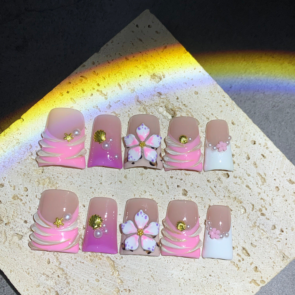 Pink French Nails with Floral Shell Accents and Soft Pearls