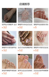 Simple french white toenail tips with black polka dot design