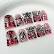 Bold Press-On Nails with Silver Charms and Pink Zebra Design