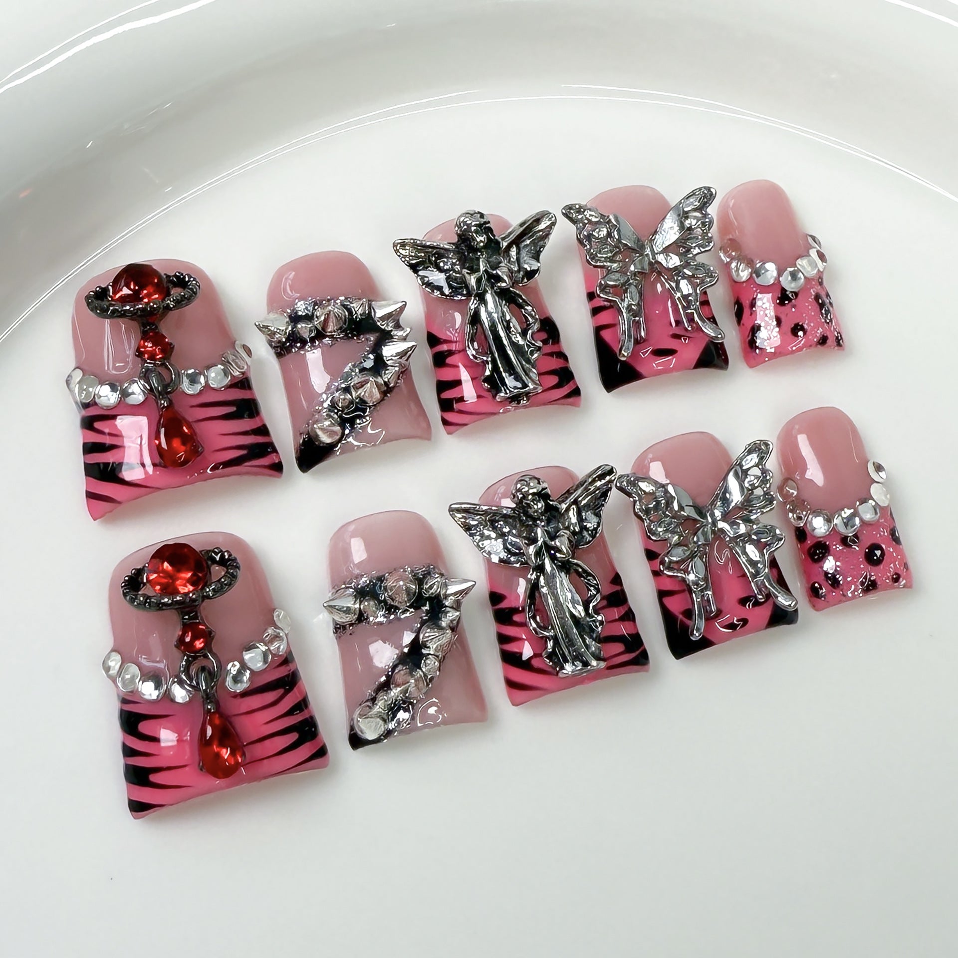 Bold Press-On Nails with Silver Charms and Pink Zebra Design