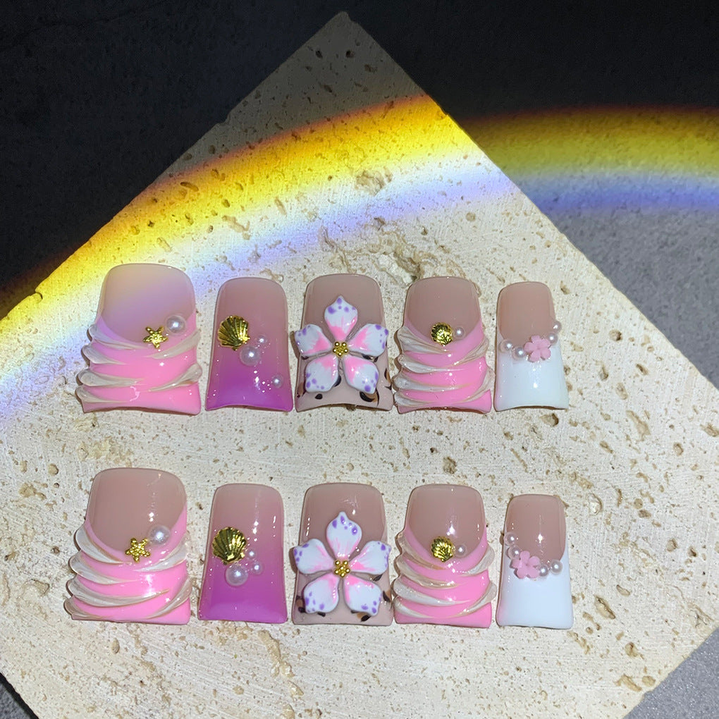 Pink French Nails with Floral Shell Accents and Soft Pearls