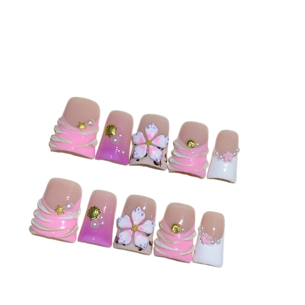 Pink French Nails with Floral Shell Accents and Soft Pearls