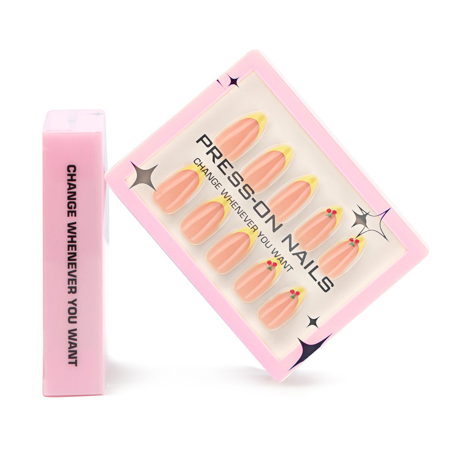 Ongles press-on forme amande style French jaune, motif cerise 3D — simple et frais
