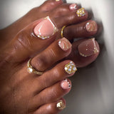 French-style toenail tips, fully embellished with sparkling rhinestones and pearls, for a dazzling, short-toe manicure