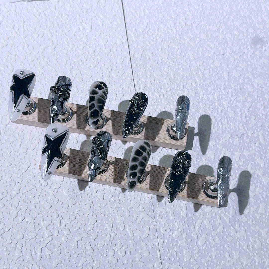 Edgy Press-On Nails with Chrome Chains and Black Star Design