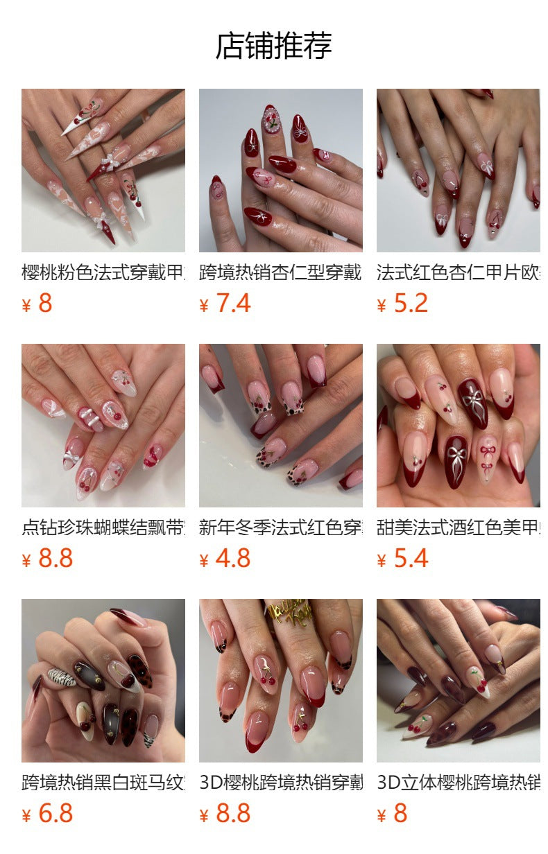 長款杏仁形穿戴甲，紅色底搭配櫻桃與蝴蝶結裝飾