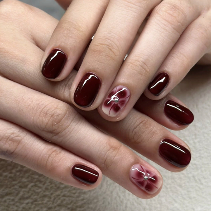 Elegant Burgundy Nails with Floral Accent Art