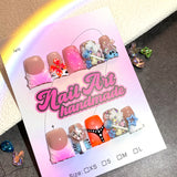 Mixed Color Nails with Sculpted Charms and Playful Details