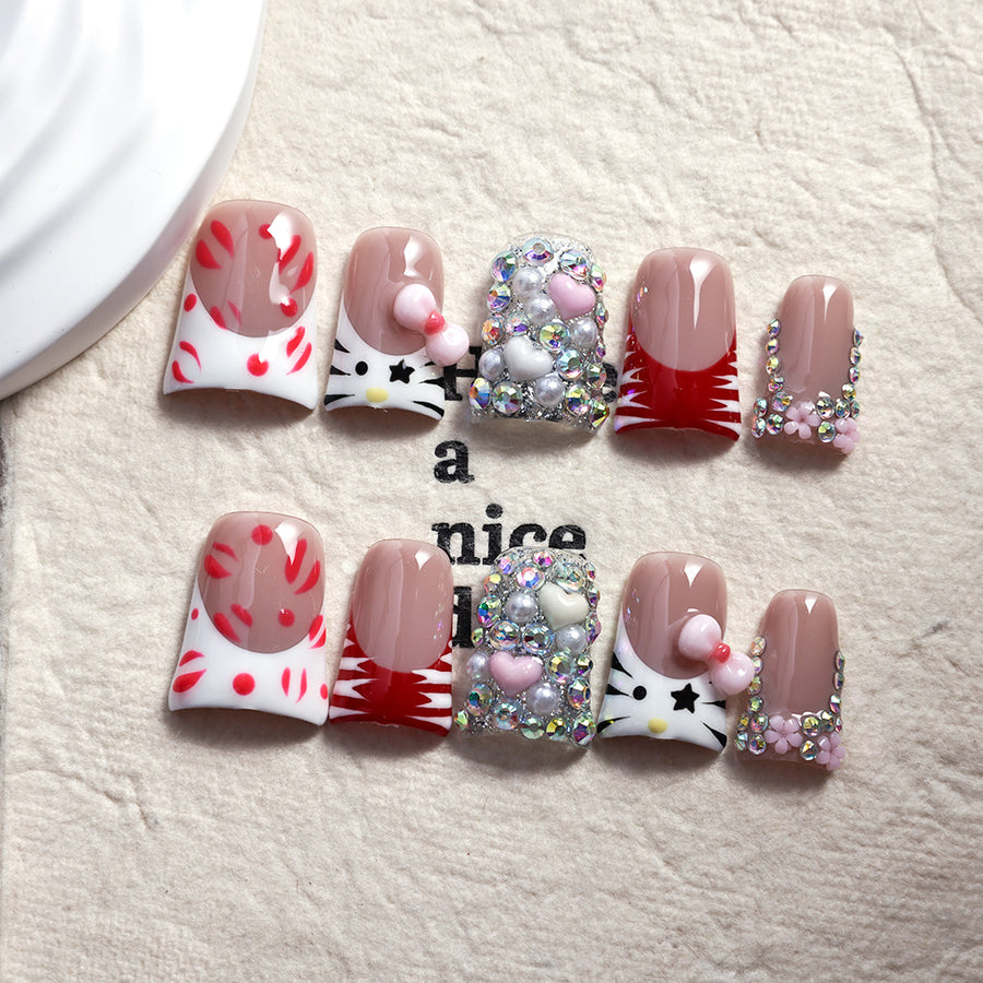 Ongles press-on rouges motif chaton ornés de cristaux